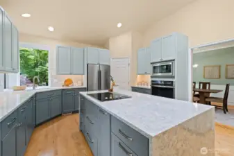 Beautifully remodeled kitchen with walk-in pantry, quartz countertops, plenty of cabinetry, stainless appliances and hardwood floors.  This is a one story rambler; so you could add a hood vent over the range quite easily if desired.