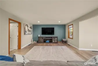 The family room leads to the laundry room and 1/2 bath to the left and the kitchen to the right