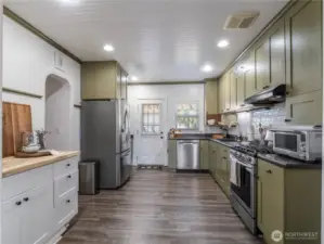 Fantastic kitchen with stainless steel appliances, fantastic lighting, and a coffee bar.