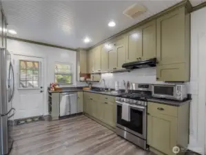 Classic craftsman-style single panel cabinet doors. Luxury laminate flooring make it easy to maintain. The door leads our to the laundry room and backyard deck.