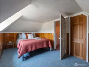 Second upstairs bedroom with wood paneled wainscoting. And...