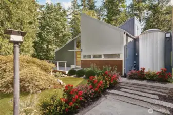 The thoughtful design for this unique home involves curved walls and a unique cylindrical connector at the heart of the home, lending a subtle “ship-like” feel to the architecture and flow of the interior. Most of the siding is new, and was selected to reflect the modern, sparse feel to the outside of the property.