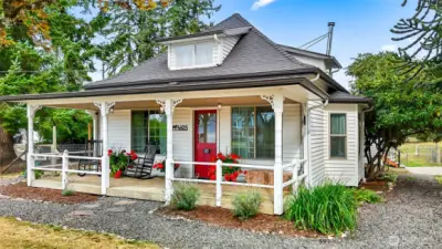Vintage farmhouse with classic covered front porch welcomes you.  Sit for a spell and relax!