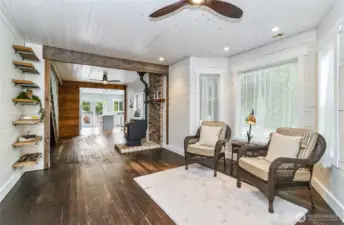 Another look at the living room and into the dining area.  Check out the natural wood beams, new pellet stove, and the character that speaks to you as you enter.