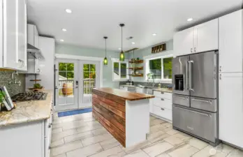 An amazing, updated kitchen.  Tons of cabinets & storage, like new appliances, butcher block island & french doors to the back deck.