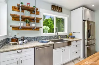 Stainless steel farm sink & open wood shelving.  So much room in this kitchen!