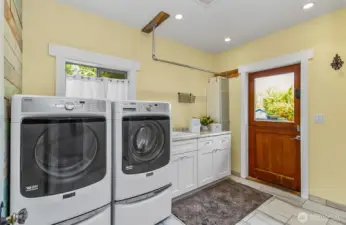 Laundry room/mud room with its own entrance from the deck.  Laundry sink, more storage and a really cool double door!