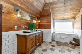A very grand primary full bath on the 2nd level, this is truly one of a kind, with luxurious soaking tub amazing lighting, and more of that natural wood along with beautiful heated tile floors.