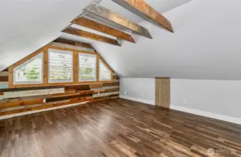 Primary bedroom is on the second level.  Wood beams and plantation shutters bring this room alive.