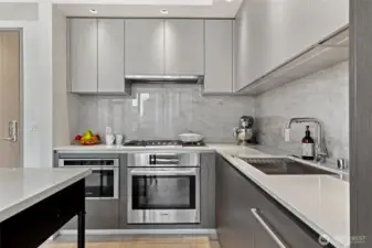 Beautiful Bosch appliances and quartz countertops, and marble back splash.