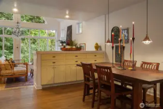 The partial walls on either side give a sense of place to the dining room and provide storage for all your pieces. Gracious flow from kitchen to dining to living.