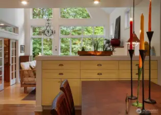 A view of the easy flow from dining to living room and the built in hutch with room for everything.  This home has storage for days!