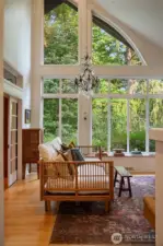The surprise of soaring ceilings framing tree tops and garden vistas.