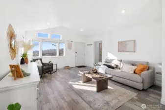 Stylish living area with modern flooring and recessed lighting.