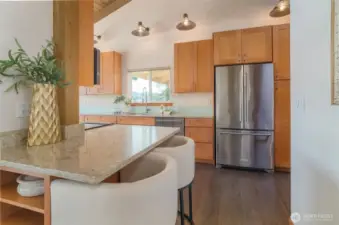 The beautiful kitchen is a delight, too.  A view of the bridge from your kitchen window, bar seating.....