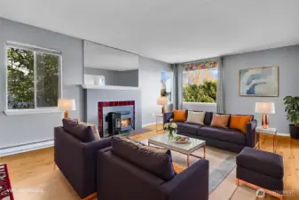 The main level unit has immaculate hardwoods, cozy fireplace, and views from multiple rooms. Virtually staged.