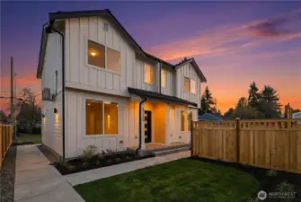 Evening exterior highlighting warm interior light and modern architecture