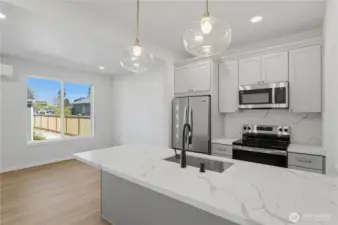 Bright kitchen with ample cabinetry and natural light