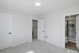 Spacious primary suite with clean finishes and ample closet space
