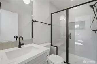 Primary bath with quartz vanity and modern fixtures