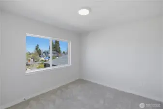 Upstairs bedroom with natural light and versatile use