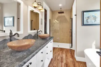 large double furniture style vanity with basin sinks. water closet room to the right of shower.