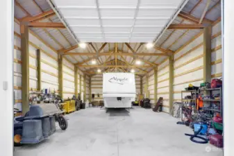 30x60x16 shop. That 38' 5th Wheel leaves lots of space around it. If that's not big enough for you then go, just go...