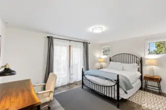 Primary bedroom with french doors that lead out to the deck