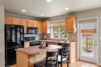 Kitchen with eating space overlook private backyard, and oversized deck