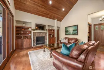 Living room with propane fireplace and cherry cabinet built-ins