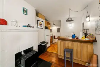 Apartment #3 - Enter apartment 3 through a large enclosed sun porch with tiled floor (great for plants, reading nook, bike storage, etc.). This coveted first floor home offers 124-year-old fir floors, fireplace with gas furnace, one bedroom with oak floors filled with light from two large windows, walk through kitchen and 3/4 bath.