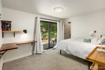Additional bedroom with ensuite bath and slider to the outdoors.