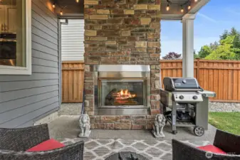 Floor to ceiling stone gas fireplace.