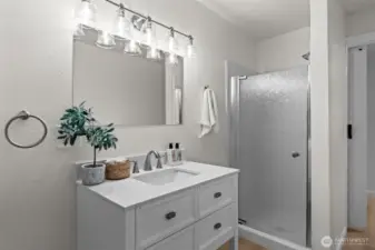 shower with a new glass door and vanity