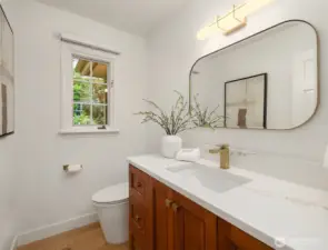 Stylish powder bath with modern finishes and natural light