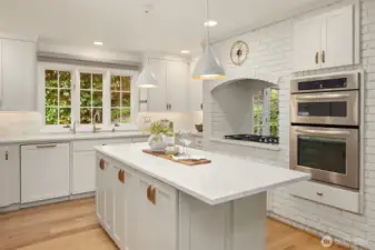 Chef’s kitchen with quartz counters, Italian tile backsplash, and smart appliances