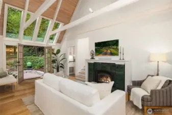Vaulted family room with fireplace, built-ins, and abundant natural light