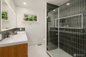 Modern bath with sleek tile shower and updated fixtures