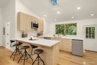 Full ADU kitchen with quartz counters, breakfast bar, and modern finishes