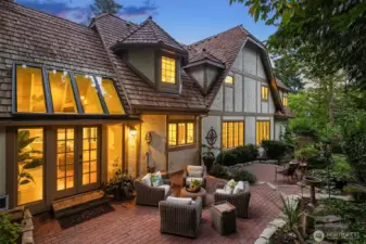 French doors open to a spacious brick patio for outdoor entertaining