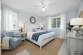 Virtually Staged guest bedroom with new flooring, paint, and light fixture.