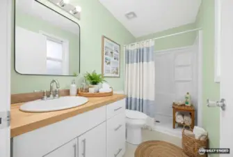 Virtually Staged updated bathroom with new vanity, butcher block countertop, fixtures and flooring.