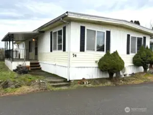 Nice size covered deck with front door to the house.