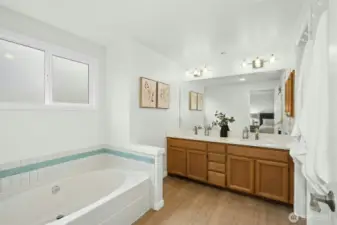 updated bathroom offering quartz counter and dual sinks.