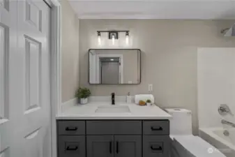 The remodeled ADU bathroom exudes modern elegance, boasting sleek fixtures and contemporary design.