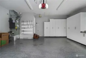 The garage features California Closets for ample storage and an epoxy floor, combining functionality and style.