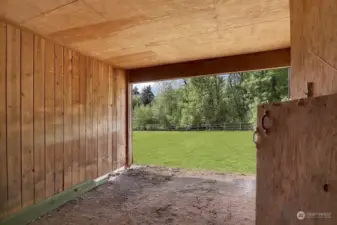 Looking from the workshop/tack room into the stable/horse stall.