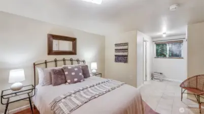 Walk into an elegant primary bedroom featuring warm LVP and tile floors and a peaceful, elevated atmosphere — the perfect space to begin and end your day.