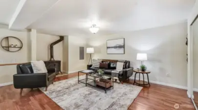 This living room includes a wood burning stove, adding warmth and comfort on chilly nights