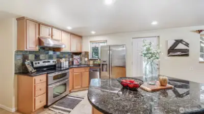 Equipped with a double oven and generous cabinet storage, this kitchen is designed for both convenience and efficiency.